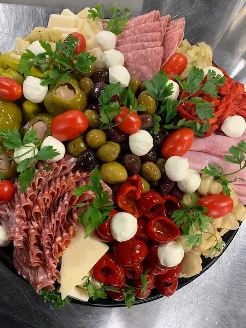 A premium antipasto platter with fresh mozzarella and roasted peppers