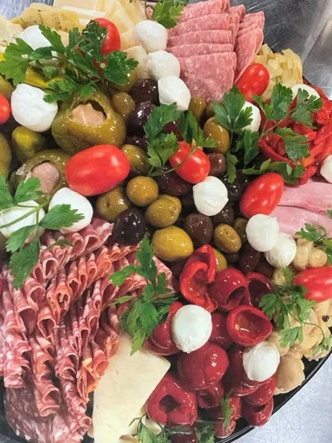 A large antipasto platter with olives and fresh mozzarella
