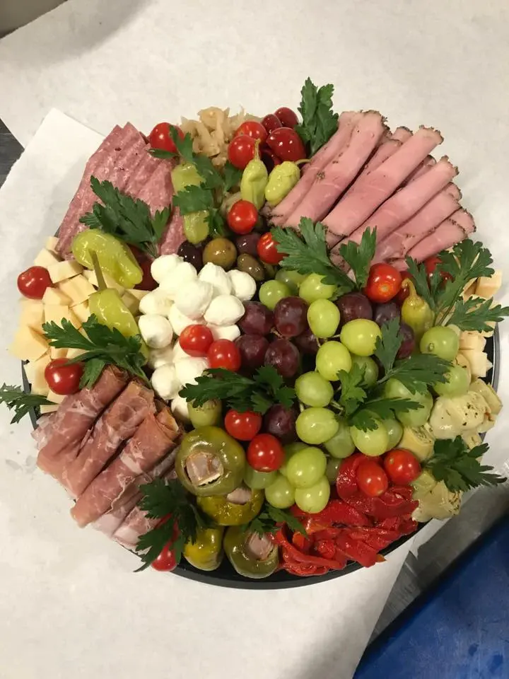 An antipasto platter with cured meats, cheeses and vegetables