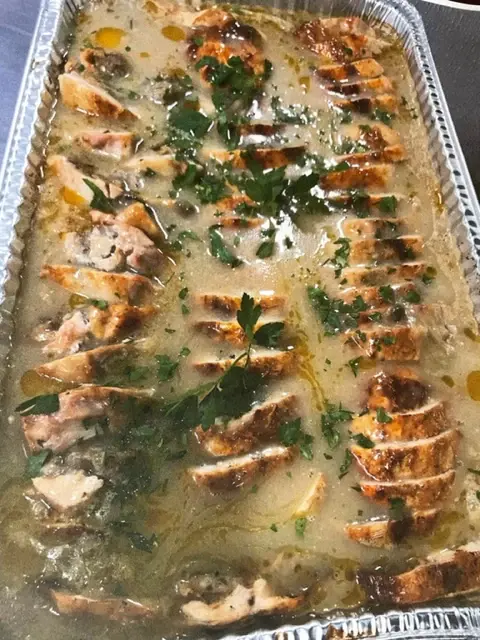 A catering tray of baked salmon