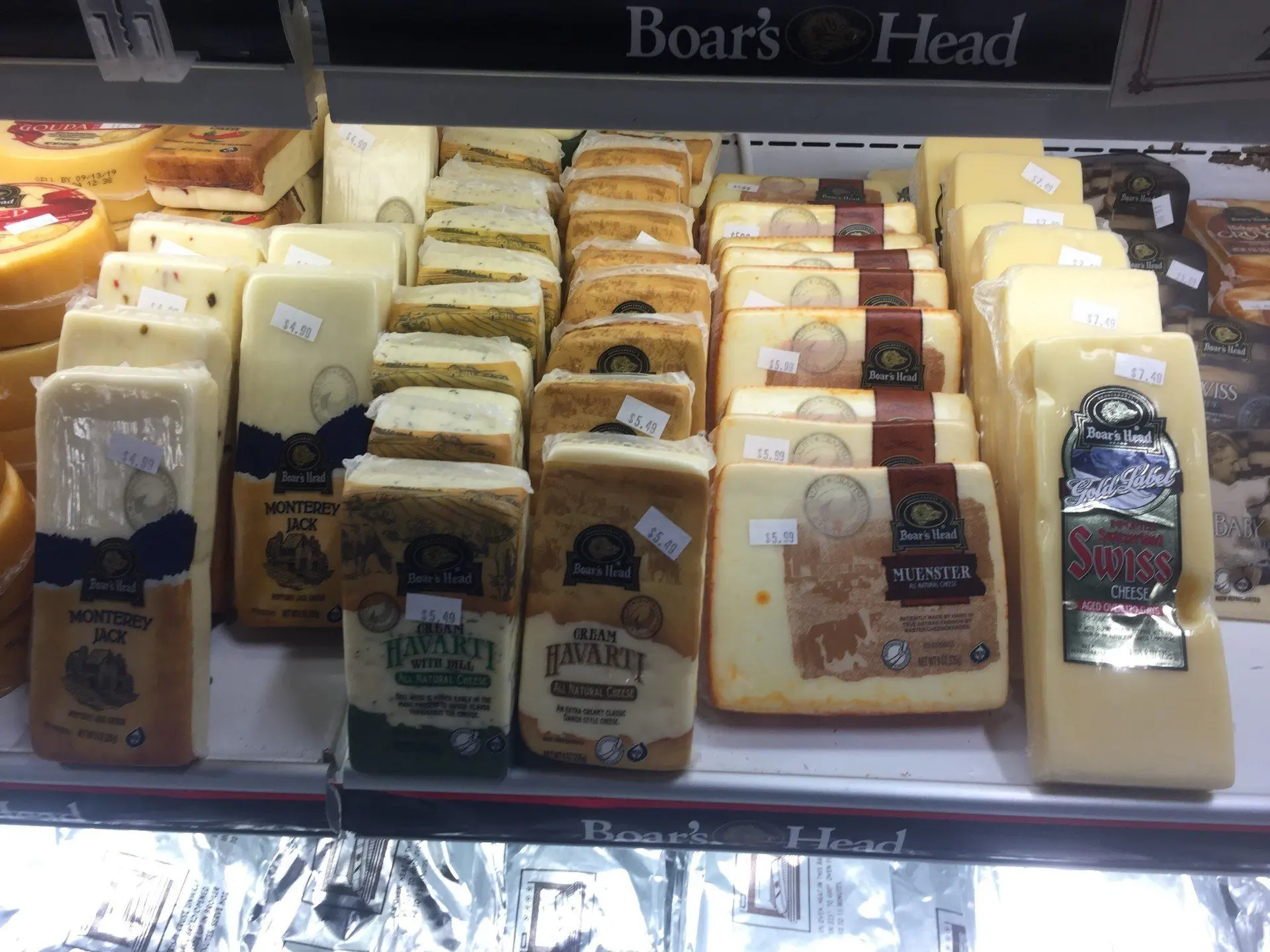 Blocks and wedges of cheese in the case