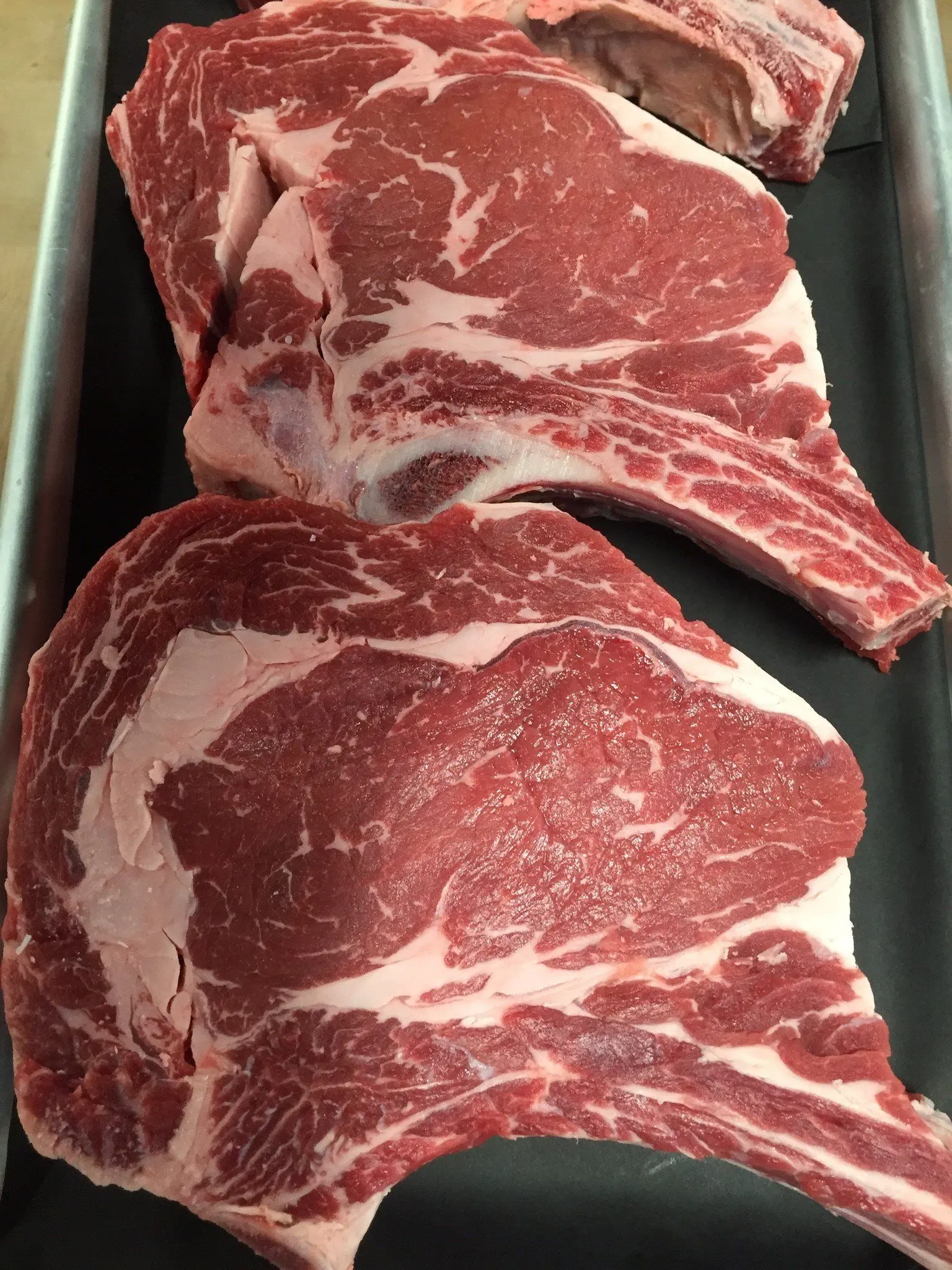 Cowboy-cut ribeye steaks trimmed in store