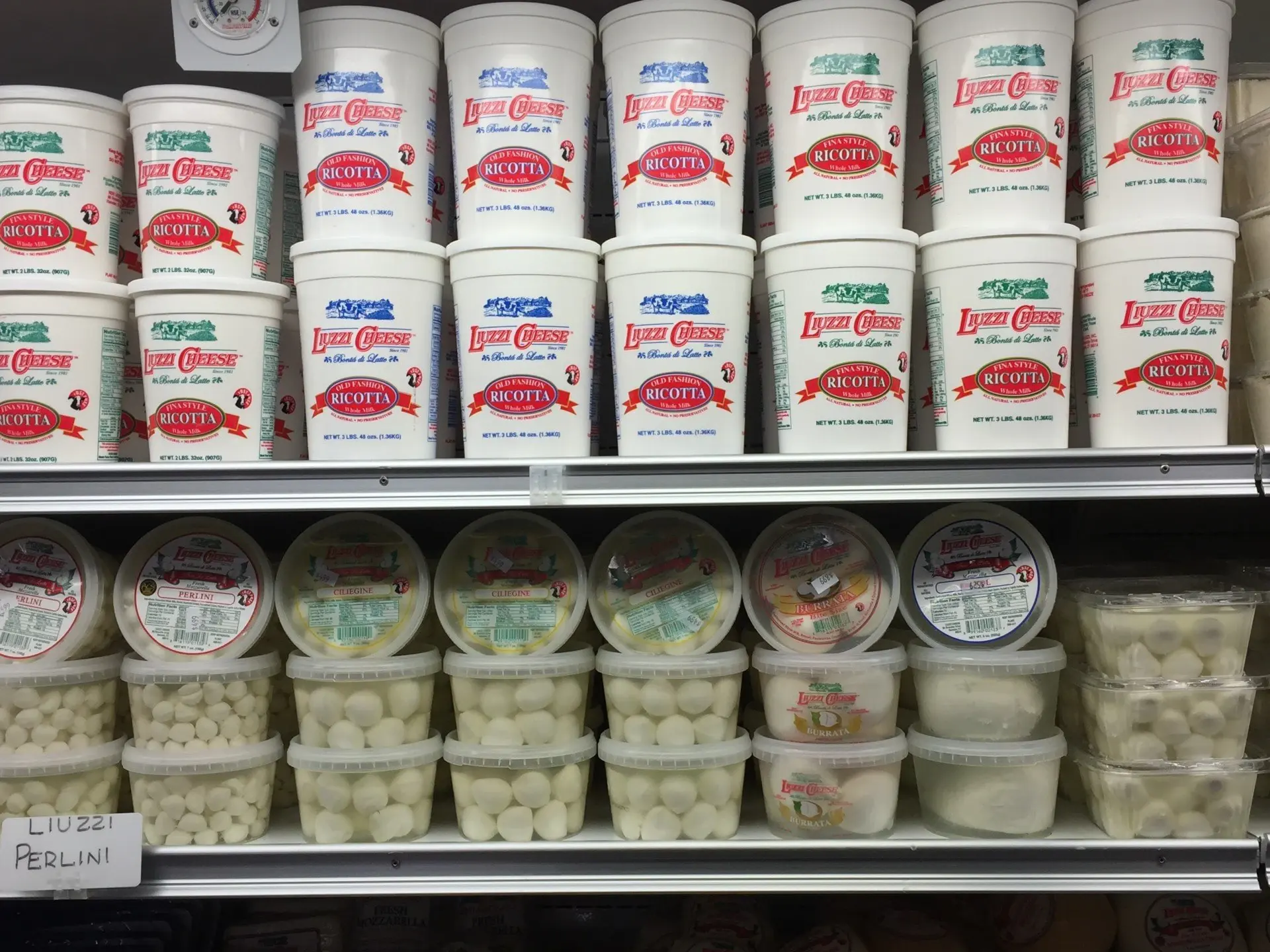 Fresh ricotta and Italian cheeses on the shelf