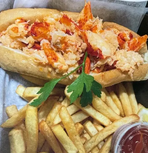 A fresh lobster roll with fries