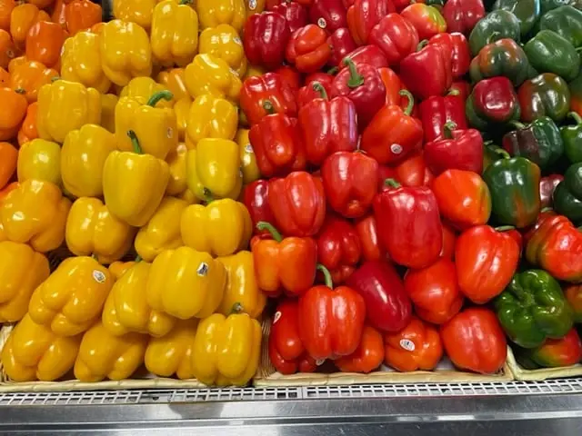 Yellow and red bell peppers on the produce table