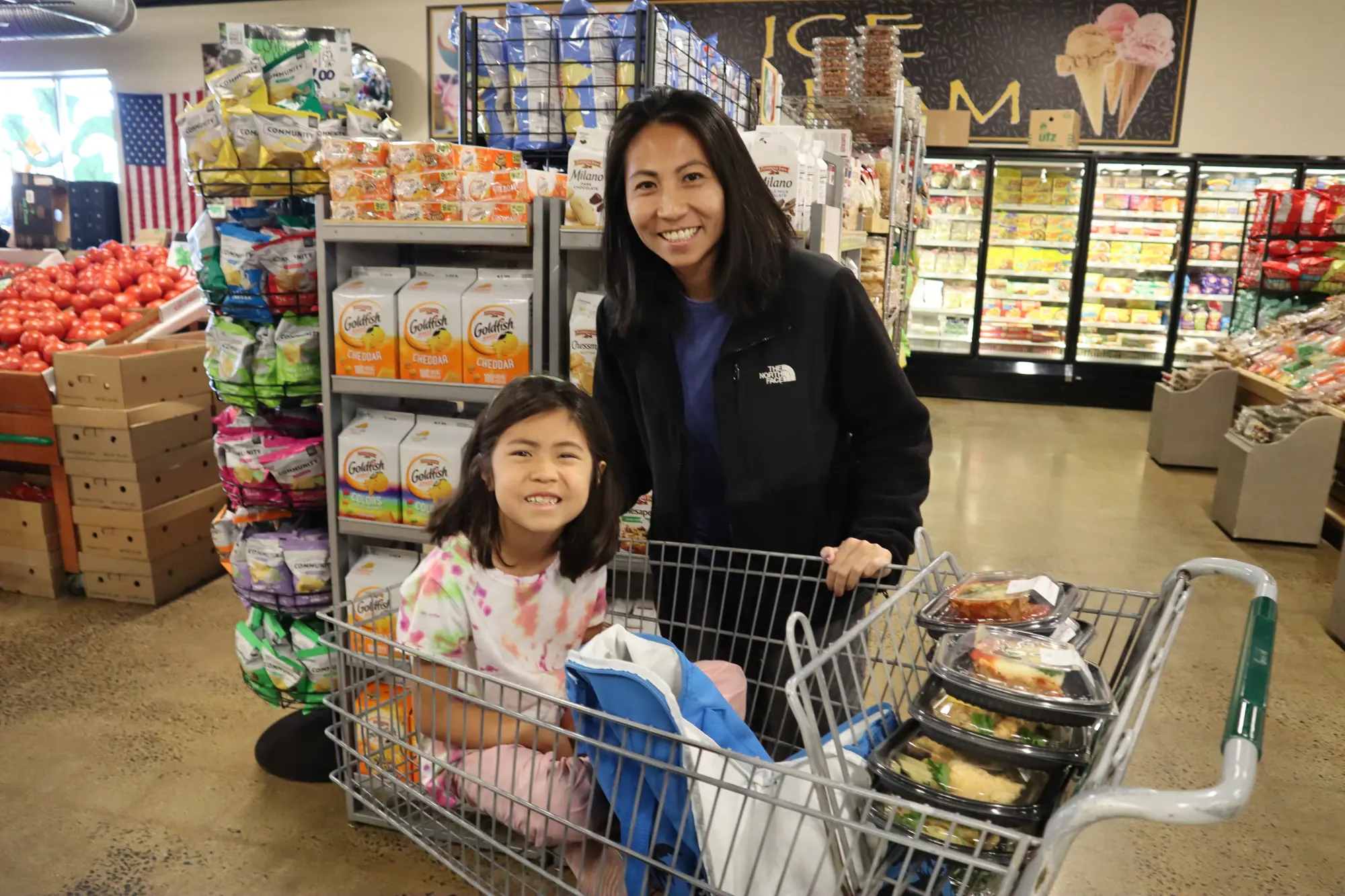 Shoppers with a cart in the produce aisle