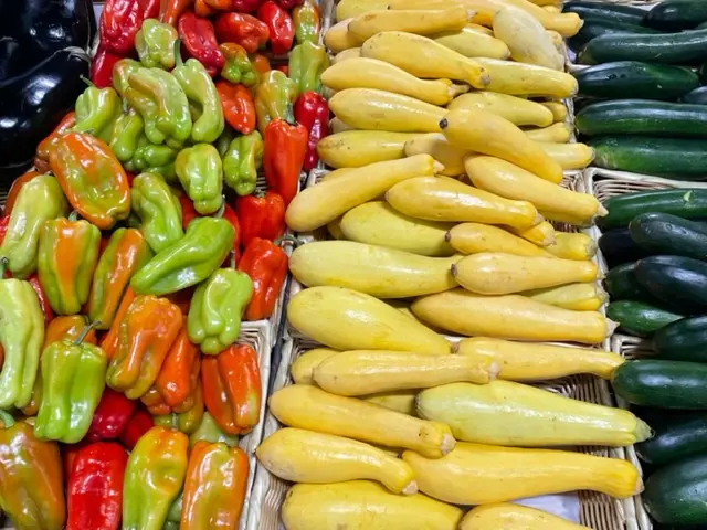 Yellow squash and peppers along the produce row