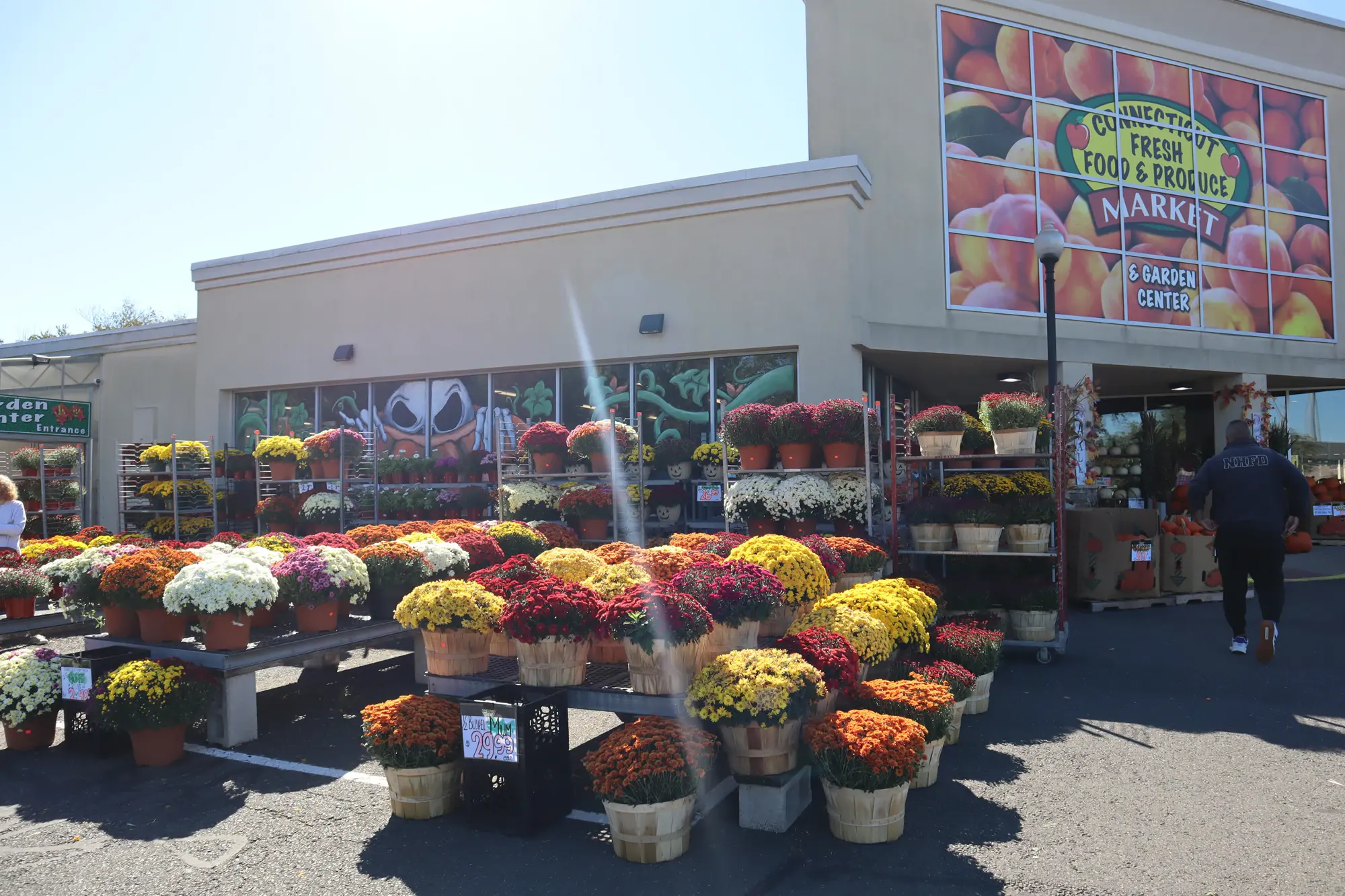The storefront with seasonal produce and plants displayed outside