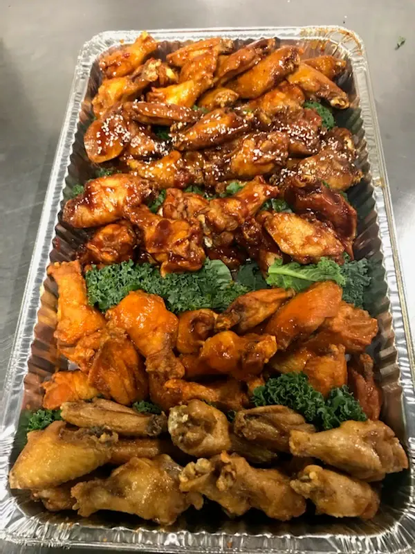 A catering tray of chicken wings
